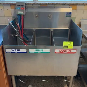 Stainless steel 3-compartment sink. Features integrated backsplash, side splashes, lever waste drain valves, and Chemstar chemical dispenser. 33 1/2" 