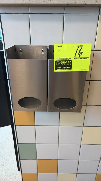Stainless steel hair net dispensers. Features stainless steel construction, open-top loading, and front oval dispensing cutouts. Wall-mounted design.