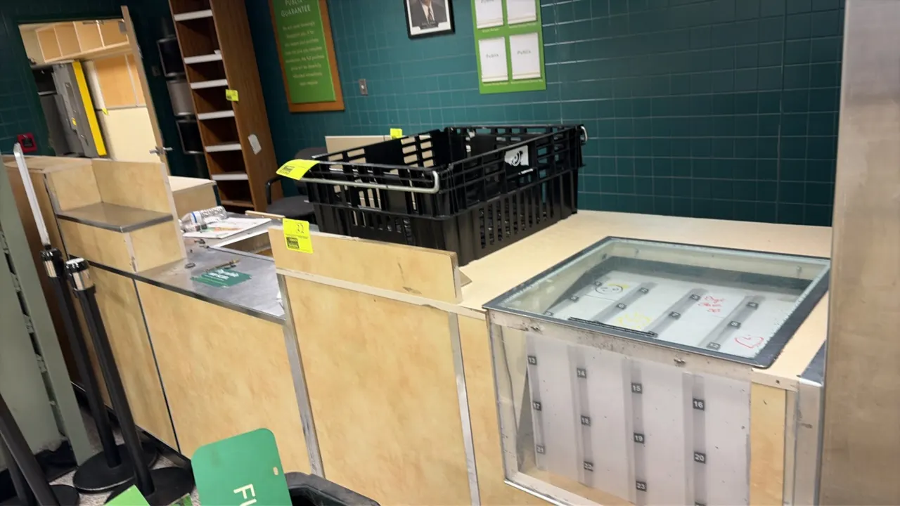 Wood laminate service counter. Features laminate and stainless steel countertops, built-in lottery or document display compartment, slide-out storage