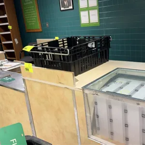 Wood laminate service counter. Features laminate and stainless steel countertops, built-in lottery or document display compartment, slide-out storage 