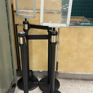 AirFlo retractable belt stanchions. Features black metal posts with circular weighted bases, black retractable belts, and (2) top-mounted sign display