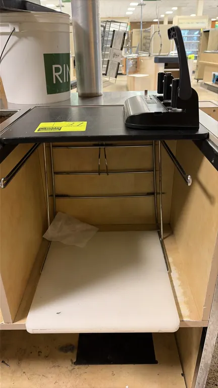 Chrome grocery bagging rack with hole punch. Includes a chrome wire bag holder with upper mounting platform and lower shelf, accompanied by a Swinglin