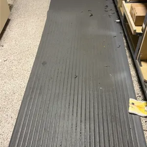 Gray rubber anti-fatigue mat runner. Features a ribbed traction surface and beveled edges. 11'L. Surrounding cabinetry and contents not included.
