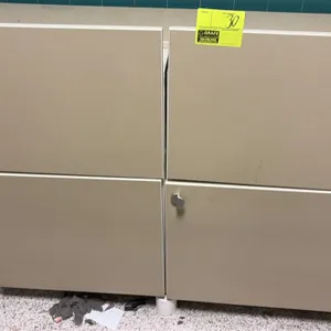 Wood laminate storage cabinet. Features two upper pull-out compartments and a lower two-door cabinet with silver-tone hardware and slide-out interior 