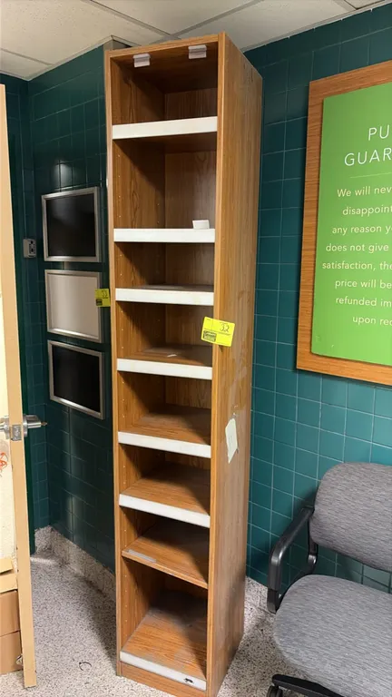 Wood laminate bookshelf. Features adjustable shelving with white front edge trim and a woodgrain finish. 15" x 16" x 88".