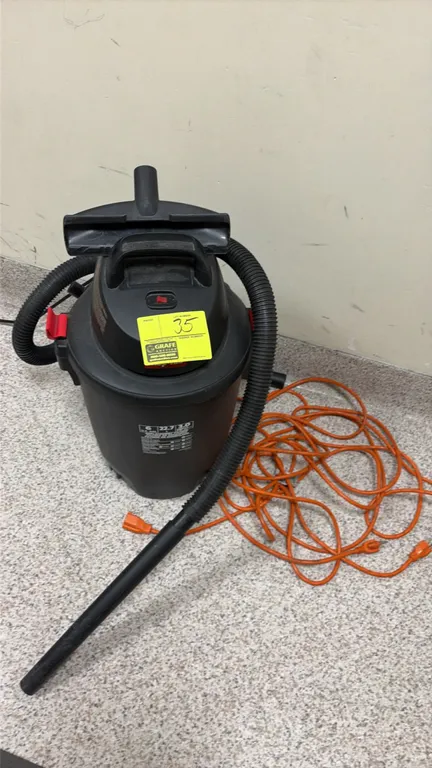 Shop-Vac 6-gallon wet/dry vacuum. Features a 3.0 peak HP motor. Includes flexible hose, extension wand, utility nozzle, and an orange extension cord.