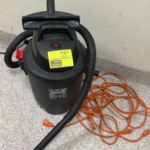 Shop-Vac 6-gallon wet/dry vacuum. Features a 3.0 peak HP motor. Includes flexible hose, extension wand, utility nozzle, and an orange extension cord.