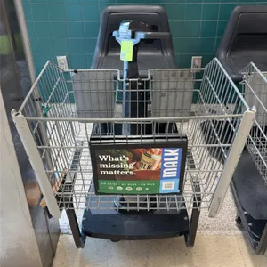 Amigo Value Shopper motorized shopping cart. Features front wire basket, molded plastic seat, steering tiller with integrated controls, and onboard ch