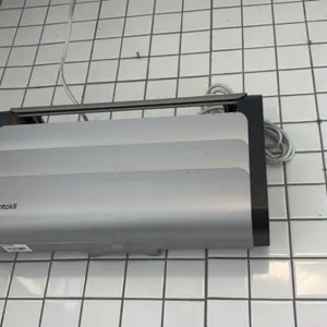 Rentokil insect light trap. Features silver-tone louvered front cover with black side panels. Designed for wall mounting. Includes attached power cord