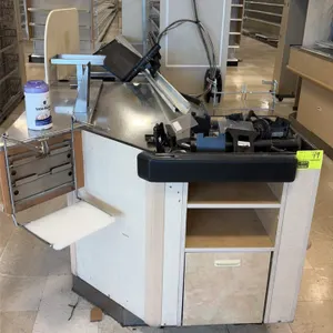 Single belt checkout lanes. Features stainless steel packing decks, bag racks, under-counter storage shelving, bumper guards, and lane divider rails. 