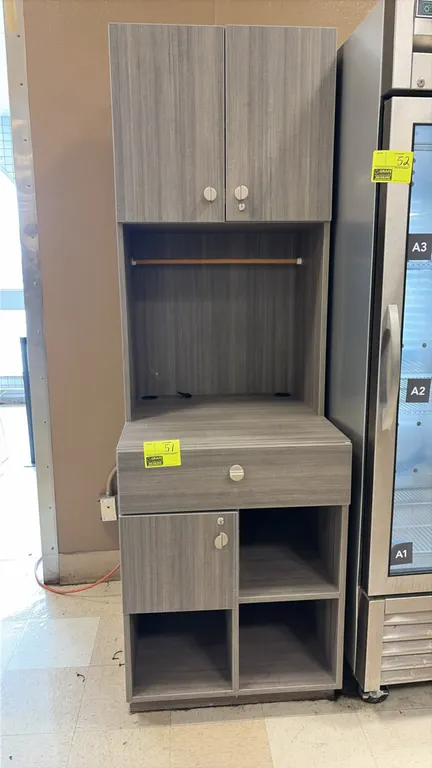Wood laminate service station cabinet. Features gray wood-grain finish, upper 2-door cabinet with interior shelf, open workspace with hanging rail and