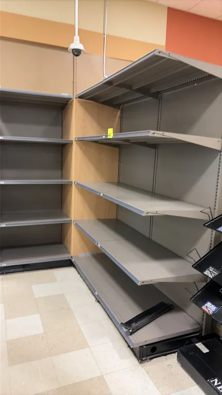 9'L of Madix wall shelving. 84"H uprights with 24"D base shelves. Features solid backing, adjustable upper metal shelves, top display canopies, and wo