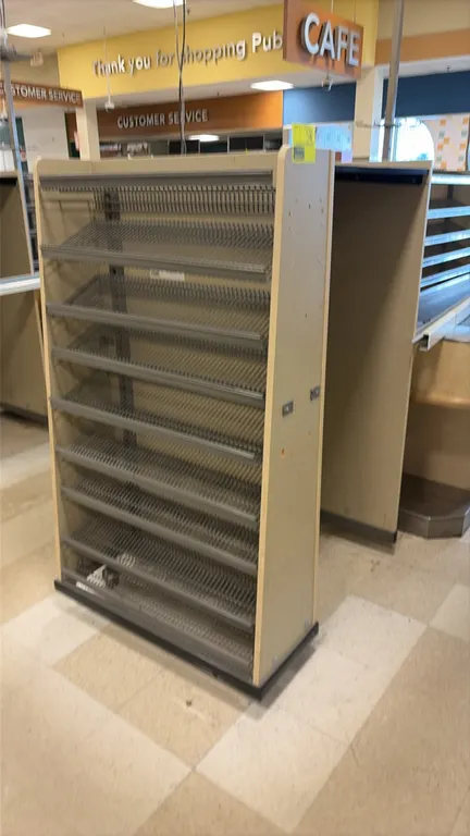 Wood laminate candy and magazine racks. Features slanted wire shelving, wire display baskets, end-panel wire literature racks, and shelf ticket moldin