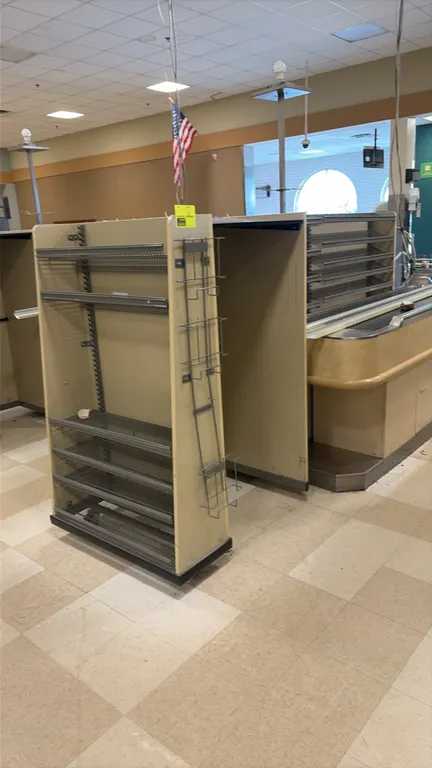 Wood laminate candy and magazine racks. Features multi-tier angled metal magazine shelves, adjustable wire display shelving, and side wire hanging rac