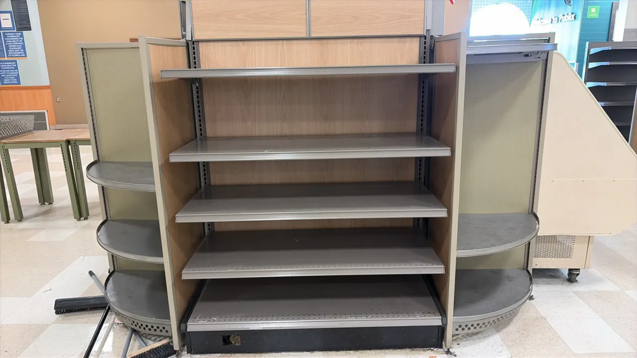 4'L of Madix shelving. 60"H with 22" base shelf. Features woodgrain backing, adjustable metal shelves, and 2' curved side shelving. Case and contents