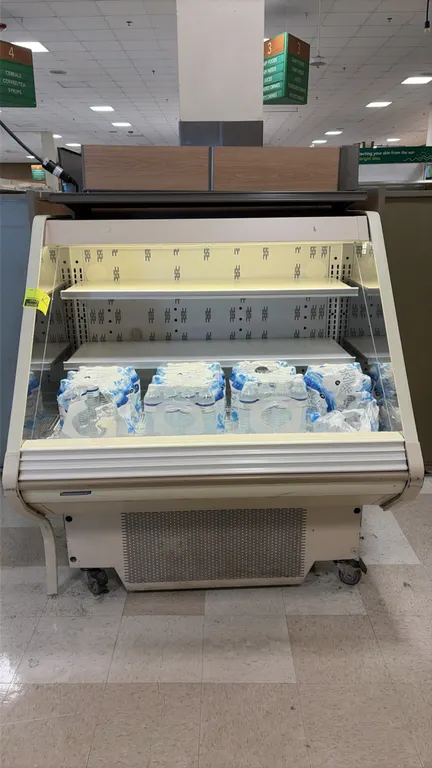 Hillphoenix O3UMA4-56 self-contained open refrigerated display case. Features adjustable metal shelving, interior lighting, and glass end panels. 4'L.
