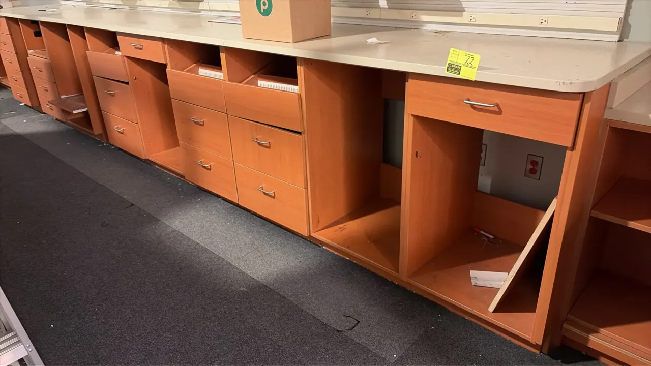 Pharmacy service center cabinet package. Features upper wall-mount cabinets with hinged doors, base cabinets with drawers and open compartments, lamin