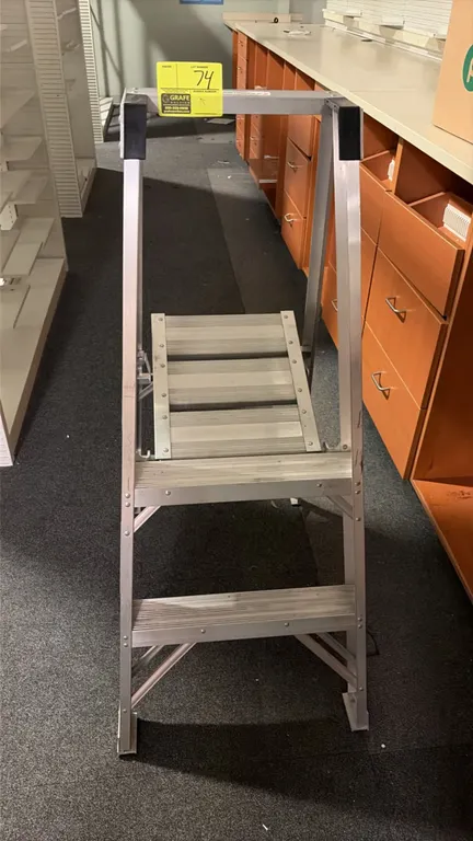Werner 2' aluminum platform step ladder. Features folding aluminum construction, slip-resistant steps, large standing platform, and top safety rail. L