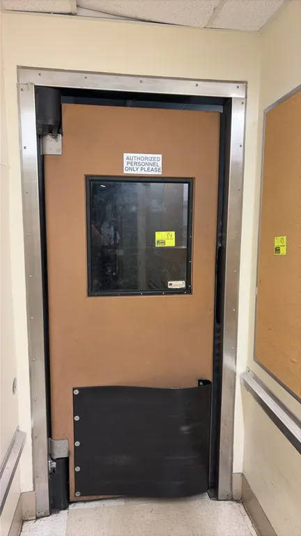 Poly swing door with frame and hinges. Features clear vision panel window and lower black impact bumper plate. Includes stainless steel door frame and