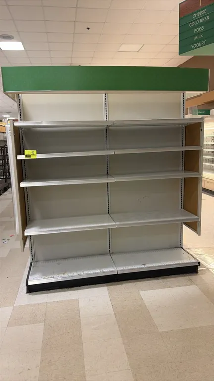 10'L of Madix end cap shelving. Features 84"H uprights, 22"D base shelves, adjustable upper shelves, solid back panels, top green canopy header, and s