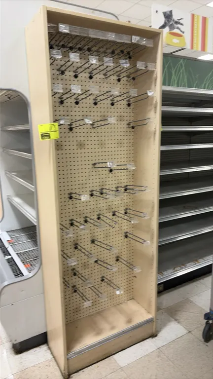 Wood laminate end cap display. Features a light finish, pegboard backing, adjustable shelving with price tag channels, and peg hooks. 2'W. Surrounding