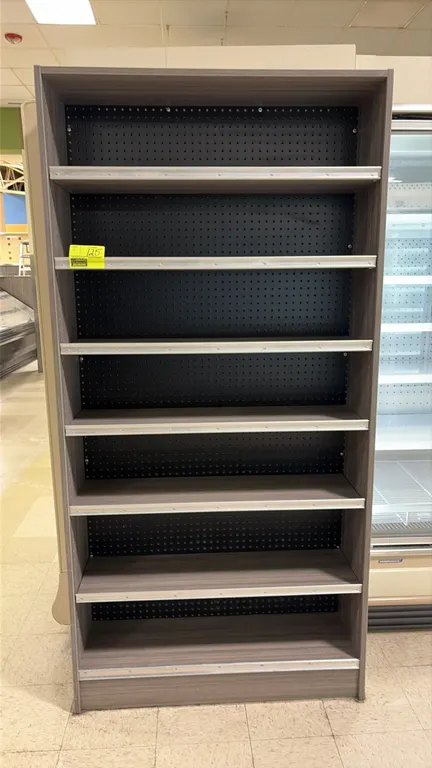 Wood laminate end cap displays. Features gray woodgrain laminate finish, black pegboard back panels, adjustable shelving, integrated shelf tag molding