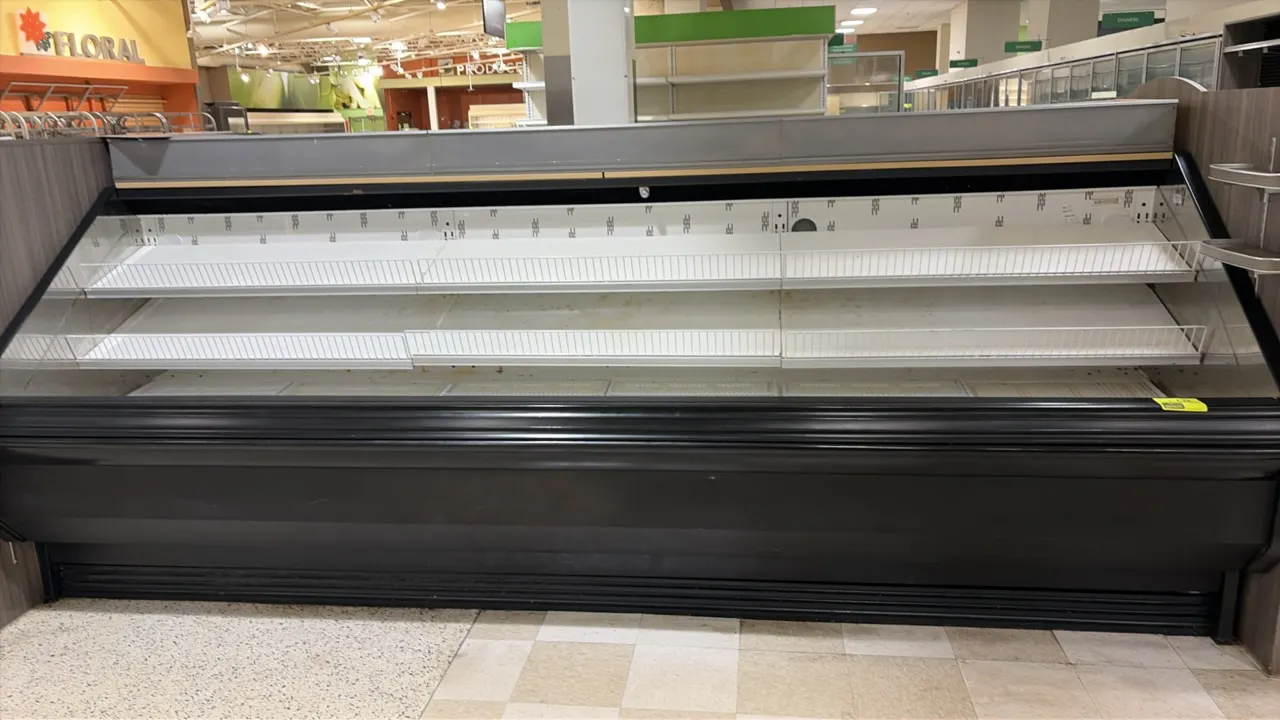 2004 Hill Phoenix O3UM12 open multi-deck deli display case. Features two rows of adjustable shelves with wire product stops, lower deck, and overhead