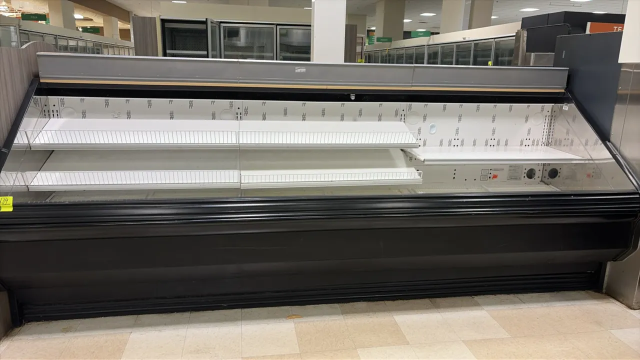 2004 Hill Phoenix O3UM12 open refrigerated deli display case. Features multi-tier adjustable metal shelving with wire product stops and bottom deck di