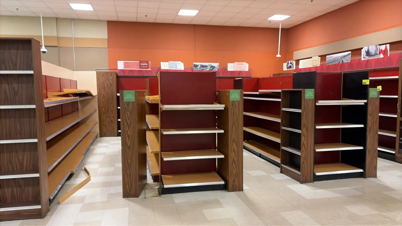 86'L of Madix gondola and wall shelving. Features 72" to 76"H uprights, 22"D base shelves, adjustable upper shelves, red back panels, and woodgrain-st