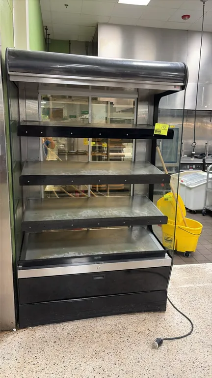 2019 Alto-Shaam HSM-48/4S-PB heated shelf merchandiser. Features 4 heated display shelves, open front grab-and-go design, sliding rear glass doors, an