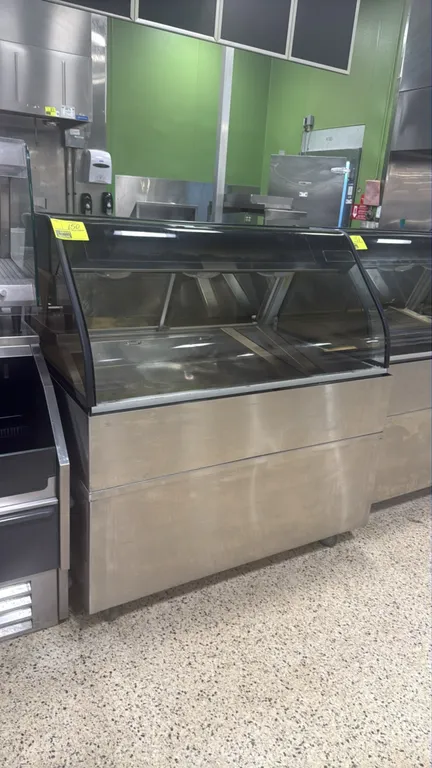 2019 Alto-Shaam ED2-48 hot food display case. Features curved glass front, rear sliding glass doors, stainless steel construction, and dual heat contr