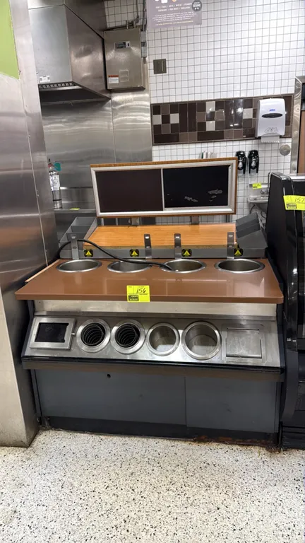 Hot soup serving counter. Features (4) heated round soup wells, raised overhead menu display board, top shelf with flanking organizer bins, and integr