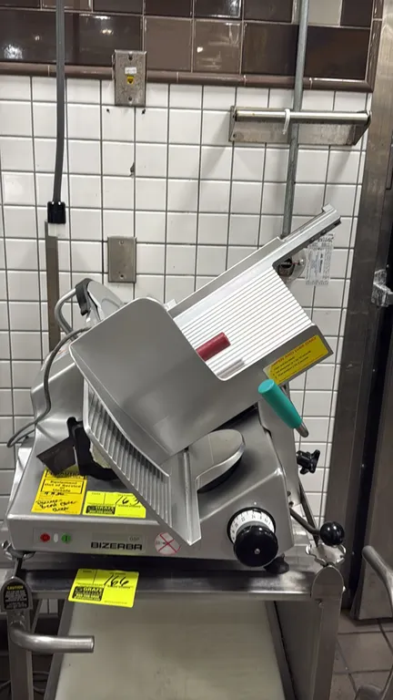 Bizerba GSP H deli meat slicer. Features gravity feed carriage, slice thickness adjustment knob, and detachable blade sharpener. S/N: 11547742. Electr