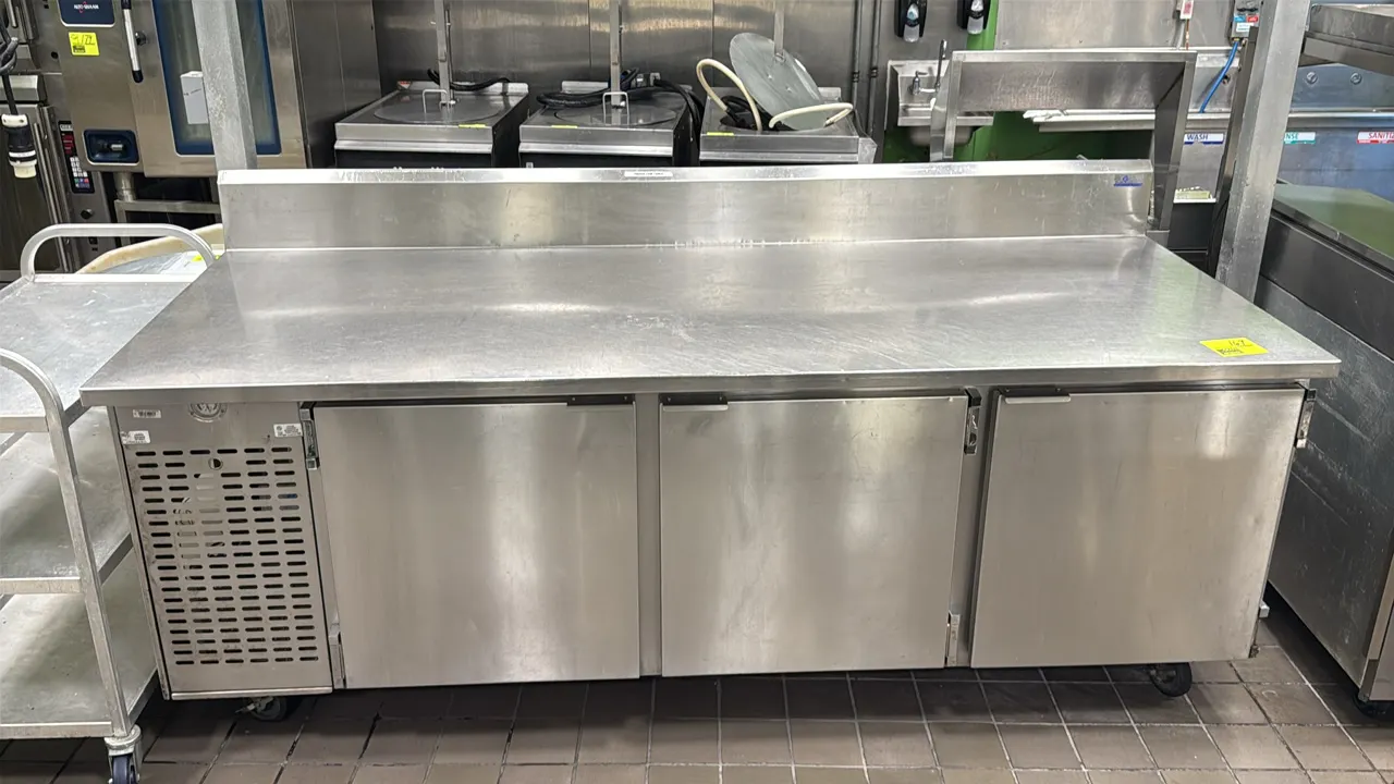 EMI Industries 3-door self-contained stainless steel flattop cooler. Features an integrated backsplash, front-facing temperature gauge, adjustable wir
