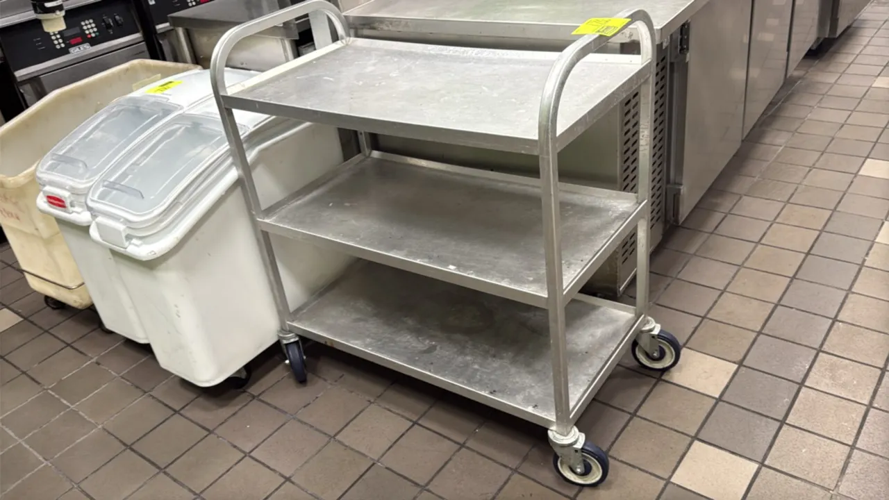 Aluminum 3-tier utility cart. Features solid aluminum shelves and integrated tubular push handles. 36"L. Mounted on swivel casters.