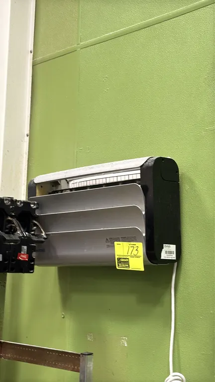 Rentokil wall-mounted insect light trap. Features a louvered front panel and black end caps. Includes attached power cord. Note: Surrounding equipment