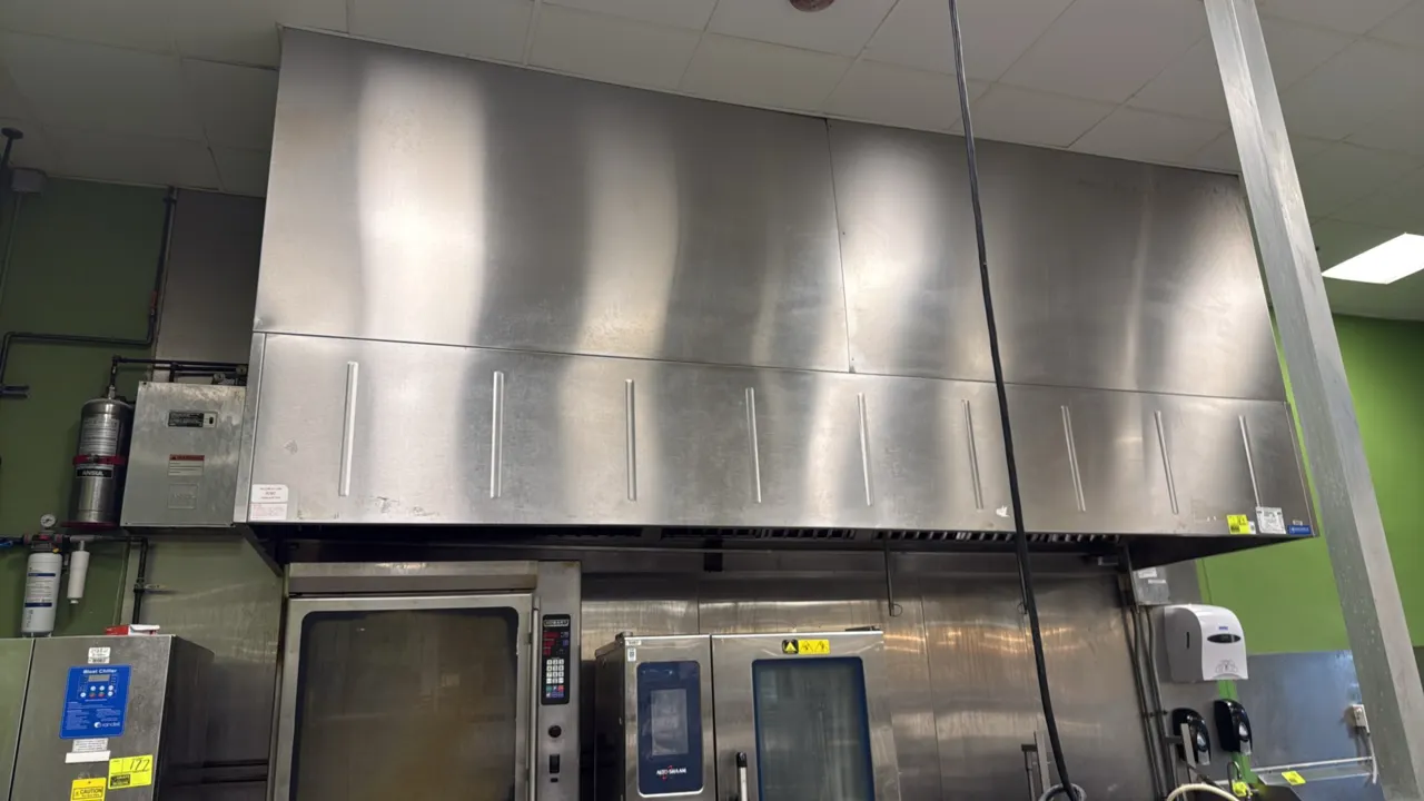 Greenheck stainless steel exhaust hood with Ansul fire suppression system. Features stainless steel baffle grease filters, vapor-proof interior lights