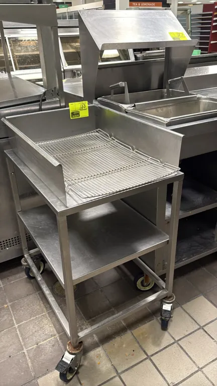 Stainless steel portable breading cart. Features a 3-sided raised containment top with removable wire rack insert and lower undershelf. 21"W. Mounted