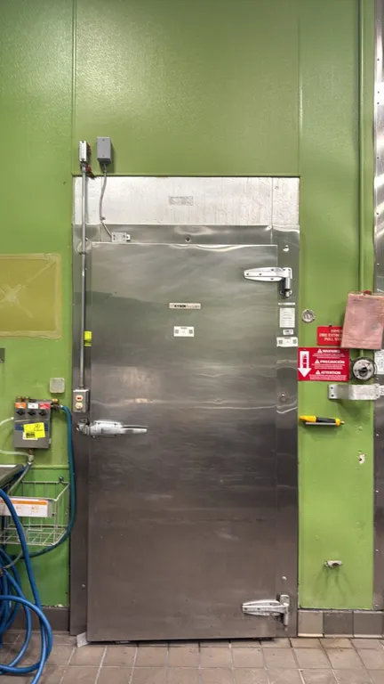 Kysor walk-in cooler. Features insulated foam panels, Bohn 2-fan evaporator coil, interior ceiling lighting, and single entrance door with heavy-duty