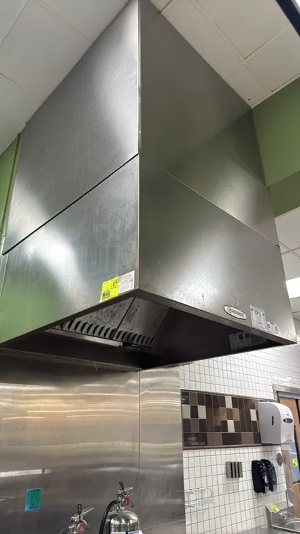 Greenheck stainless steel exhaust hood. Features stainless steel construction, baffle grease filters, and interior lighting fixtures. 48" x 51". Surro
