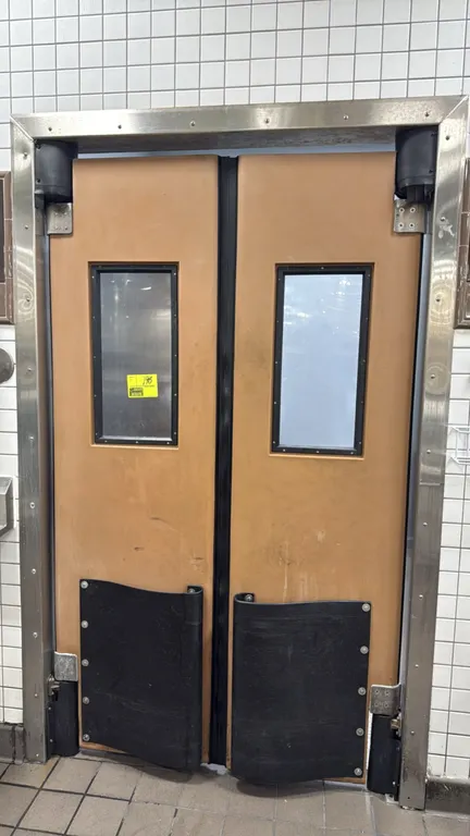Chase polyethylene swing doors. Features integrated vision panel windows and lower black impact bumpers. Dimensions: 23"W x 81"H each. Includes swing