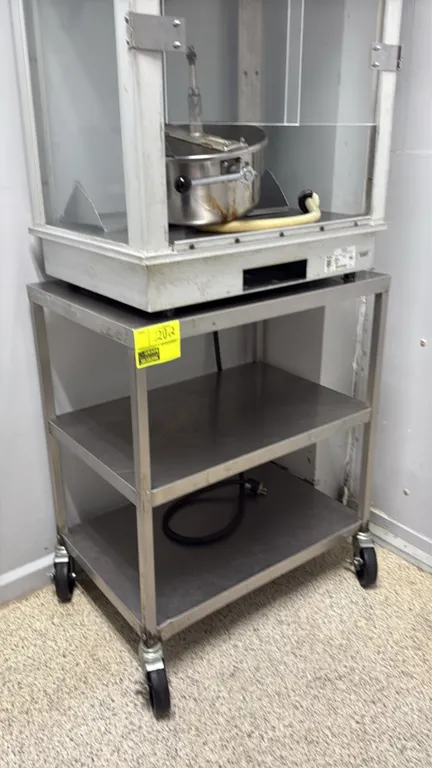 Stainless steel 3-tier cart. Features an open 3-tier shelf design. 30" x 20". Mounted on swivel casters. Note: Popcorn machine on top not included.