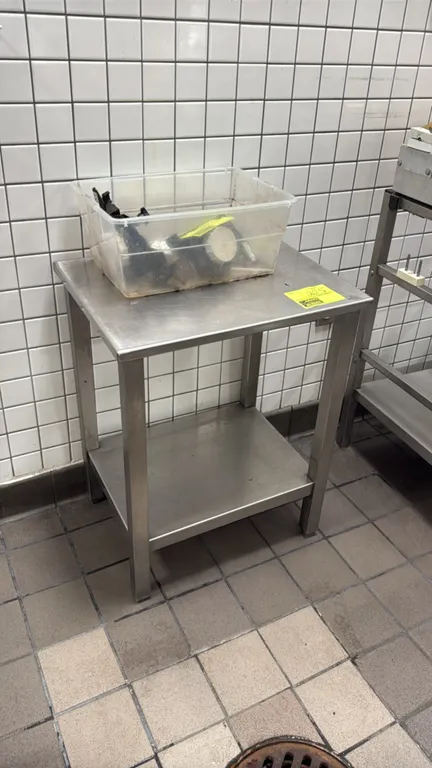 Stainless steel stand with undershelf. Features square tubular legs. 22" x 17" x 28"H. Contents not included.