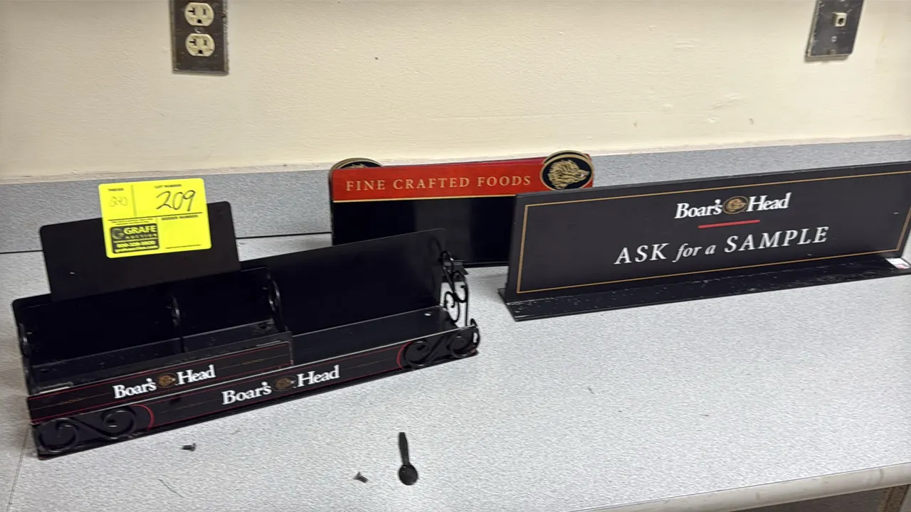 Boar's Head advertising display lot. Includes an "Ask for a Sample" countertop sign, a "Fine Crafted Foods" countertop sign, and a branded metal count