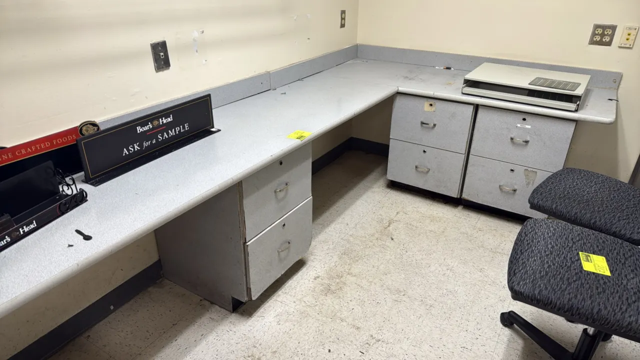 Laminate office workstation counter and base cabinets. Features an L-shaped configuration with integrated 4" backsplash, multiple 2-drawer storage/fil