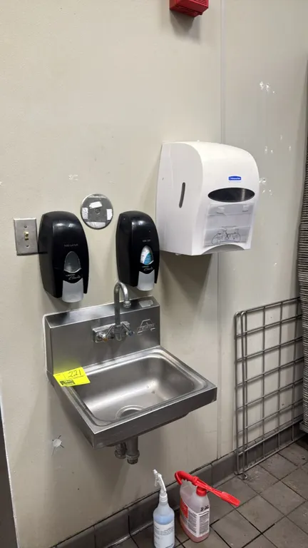 Advance Tabco stainless steel hand sink. Features a splash-mount gooseneck faucet with dual temperature controls. Includes (2) Clario wall-mount dispe