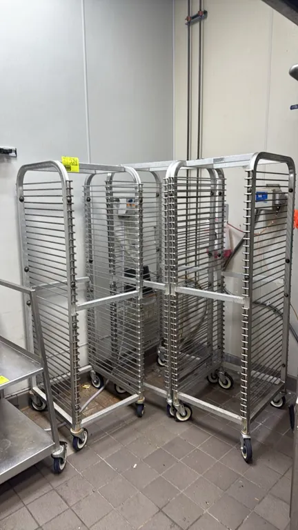 Aluminum front-load sheet pan channel racks. Features open-frame aluminum construction and multi-tier pan slides. Mounted on swivel casters.