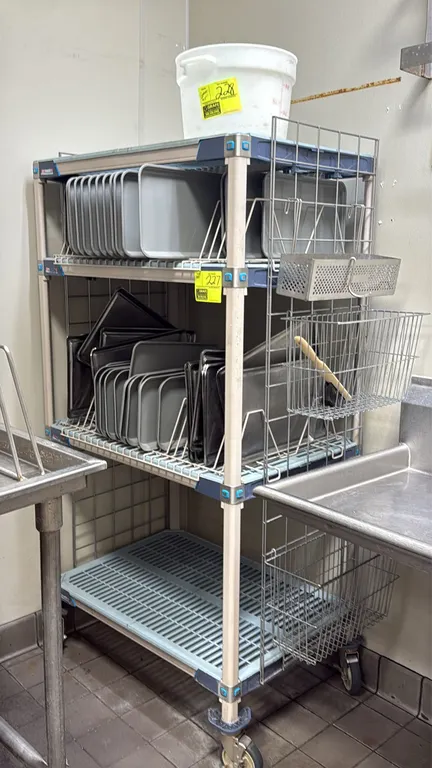 Metro MetroMax portable shelving rack. Features 4 tiers with vented shelf mats, tray dividers, and side-mounted wire baskets. 36" x 24" x 68". Mounted