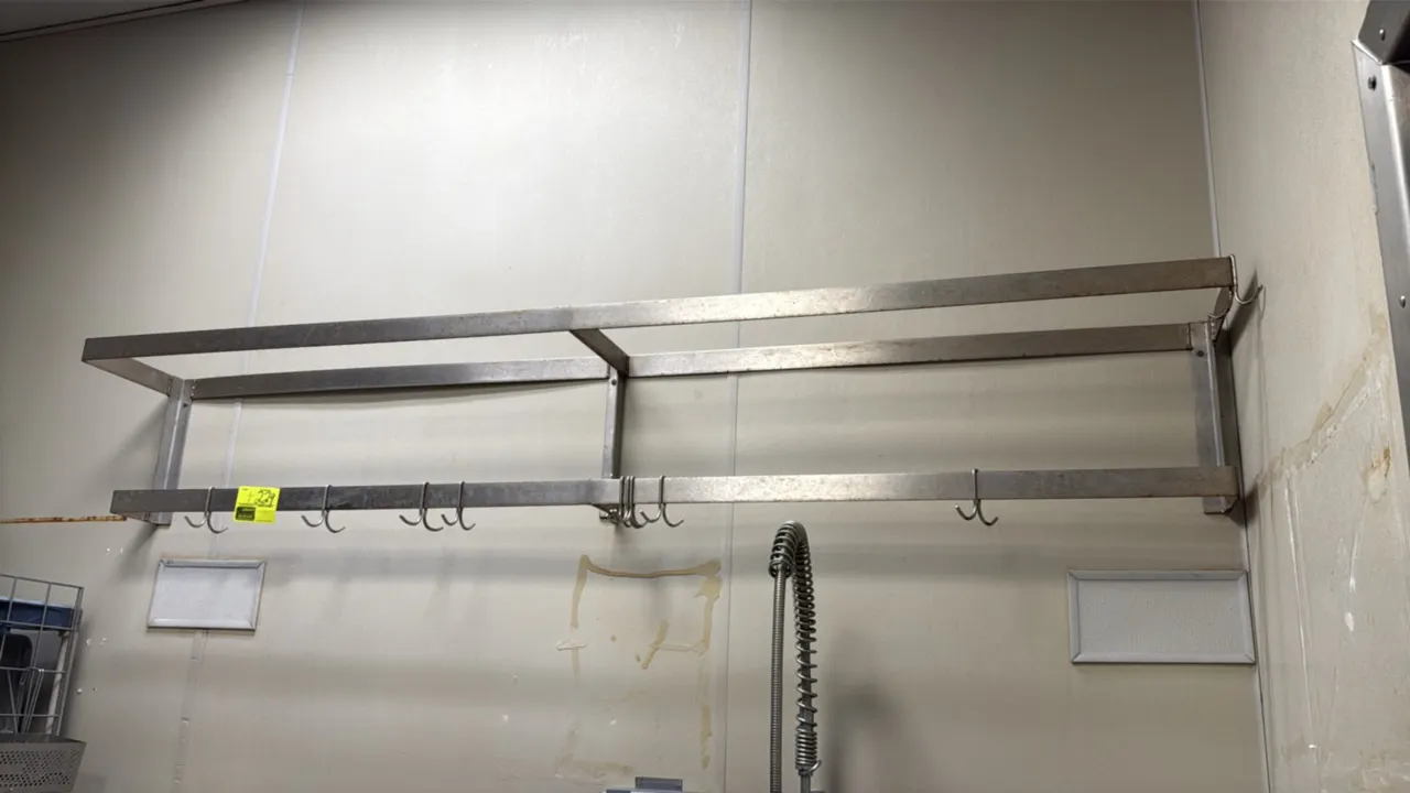 Stainless steel wall-mounted pot rack. Features stainless steel bar construction and includes hanging pot hooks. 92"L.
