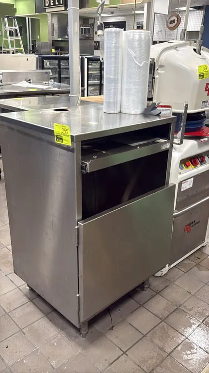 Stainless steel receiving desk cabinet. Features a flat work top with cord passthrough cutout, slide-out keyboard or utility tray, and lower single-do